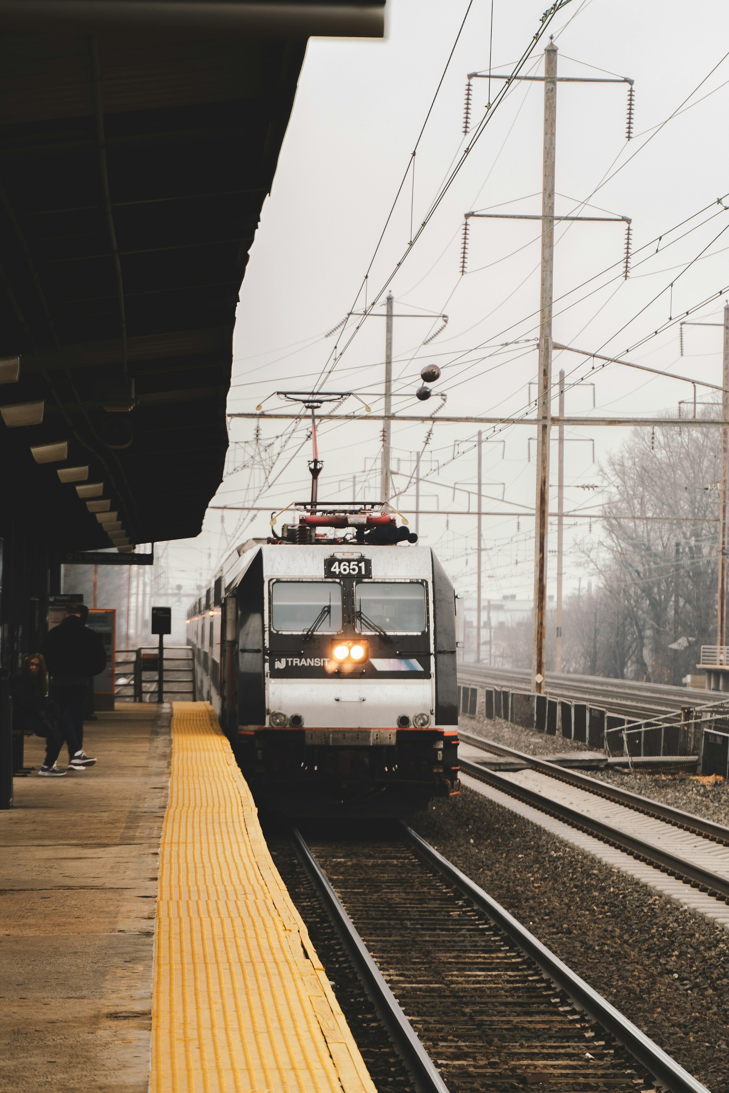 white and black train on rail tracks during daytime